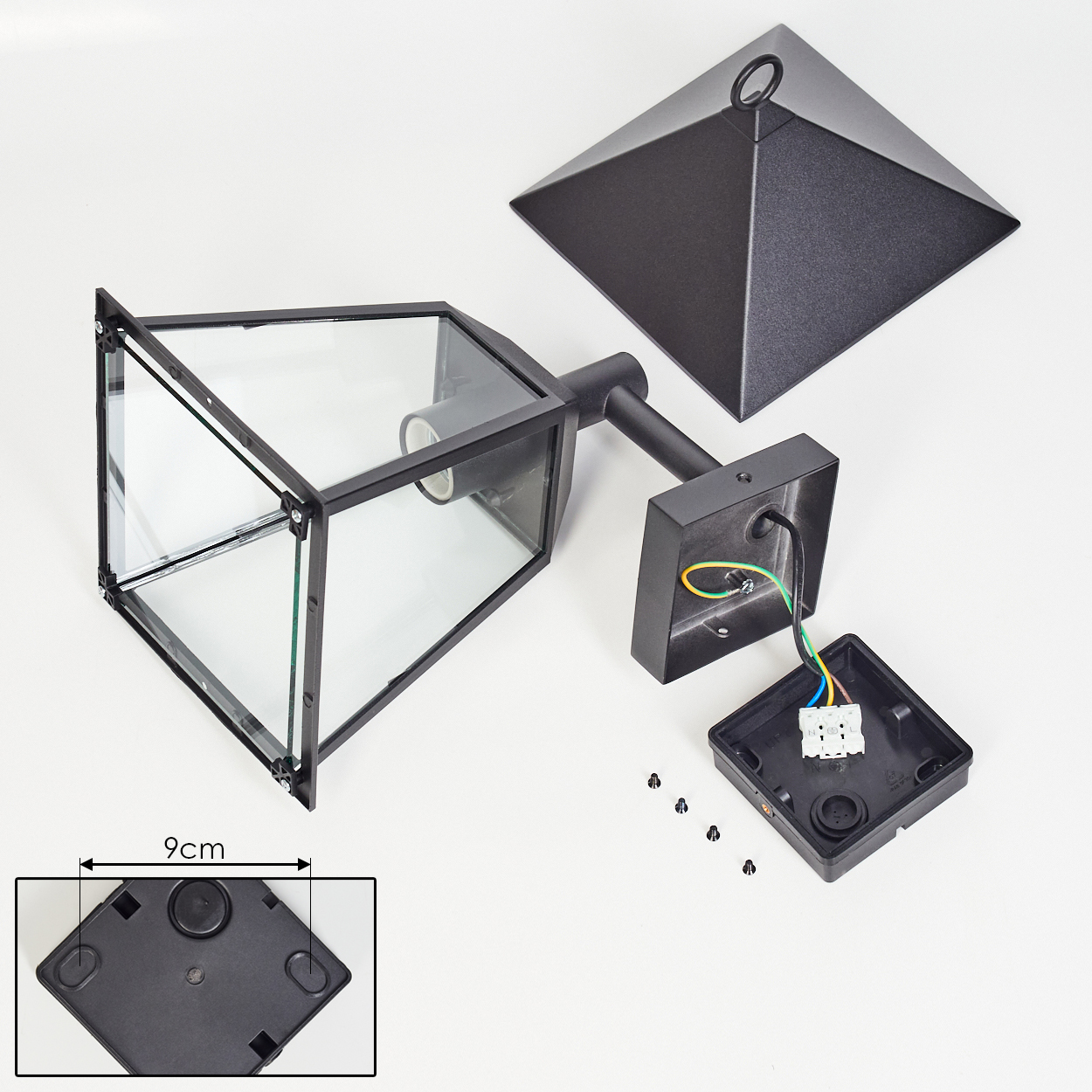 Zerlegte schwarze Lampe mit Glasscheiben. Teile umfassen einen Deckel, einen Lampenkörper, eine Anschlussdose und Schrauben. Eine 9cm Messung ist gezeigt.