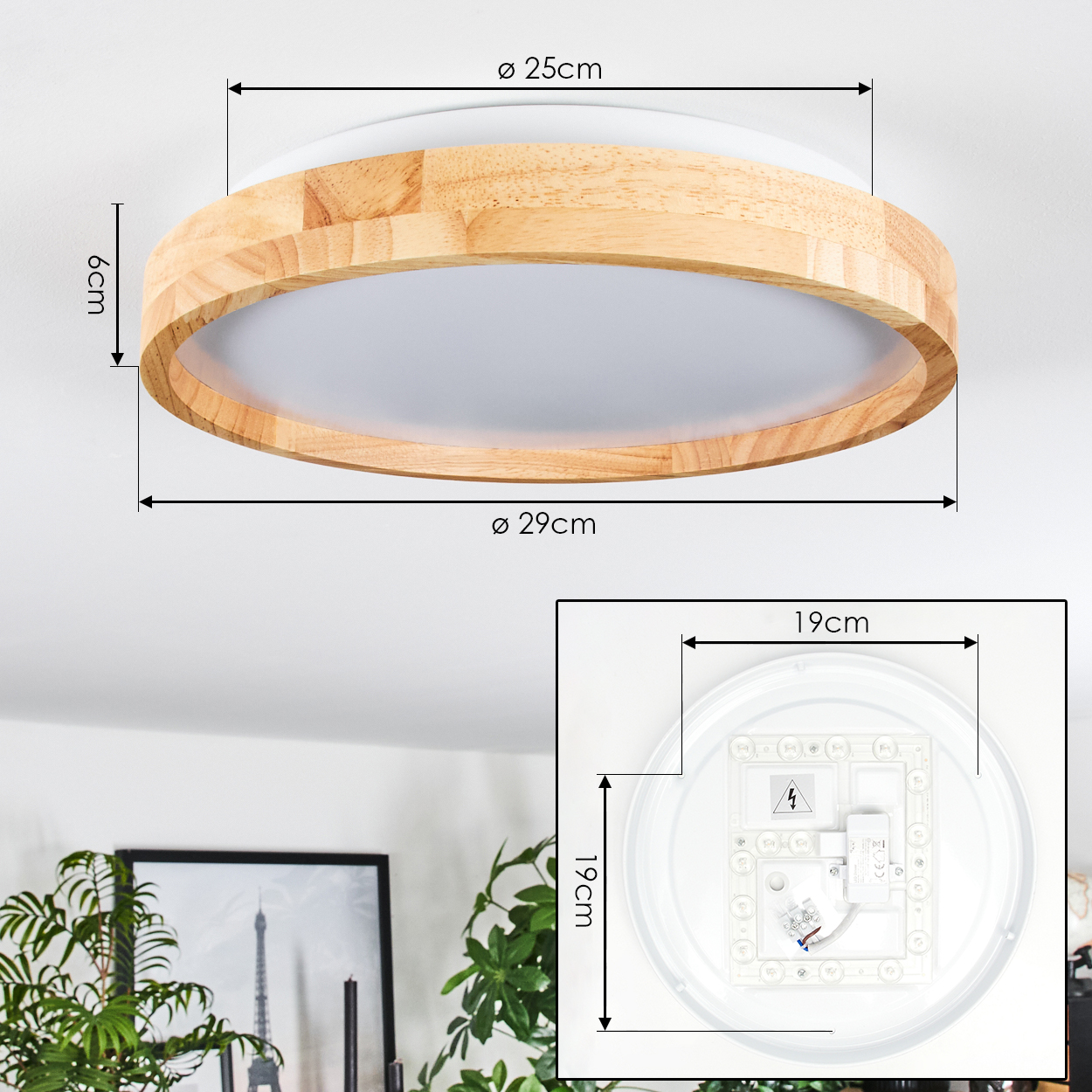 Eine runde Deckenlampe aus Holz mit markierten Abmessungen. Unten sind die internen Komponenten zu sehen. Pflanzen und ein gerahmtes Bild im Hintergrund.