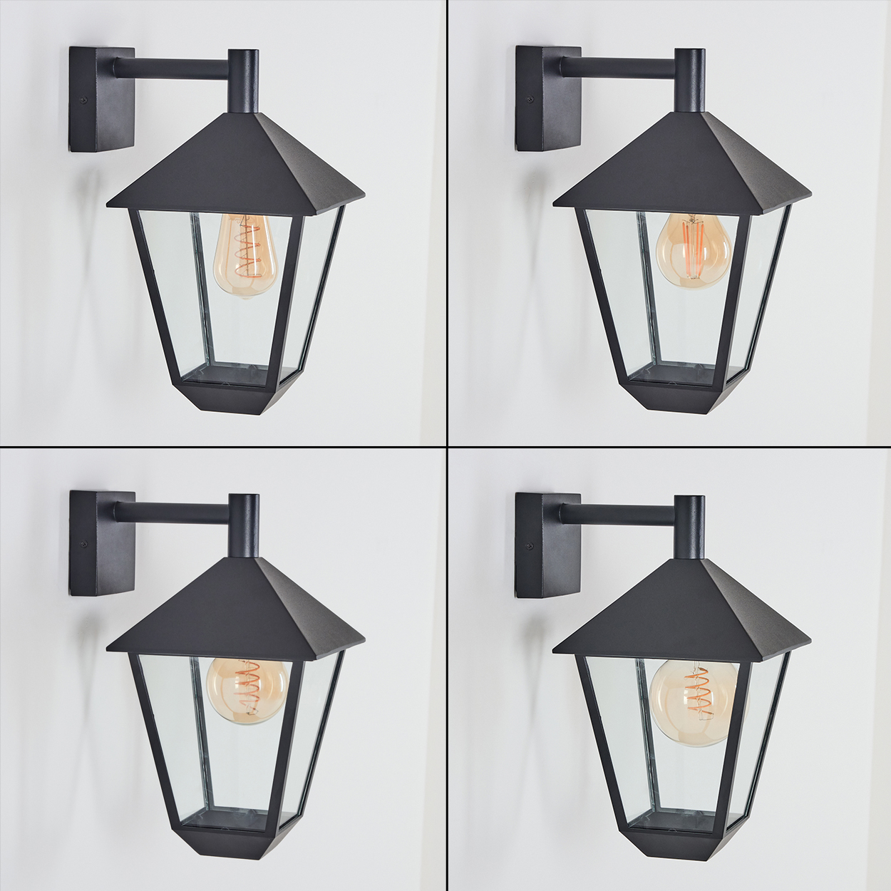 Vier schwarze Wandlampen mit Glasscheiben und freiliegenden Glühbirnen sind an einer weißen Wand montiert. Jede Lampe hat eine andere Birne.