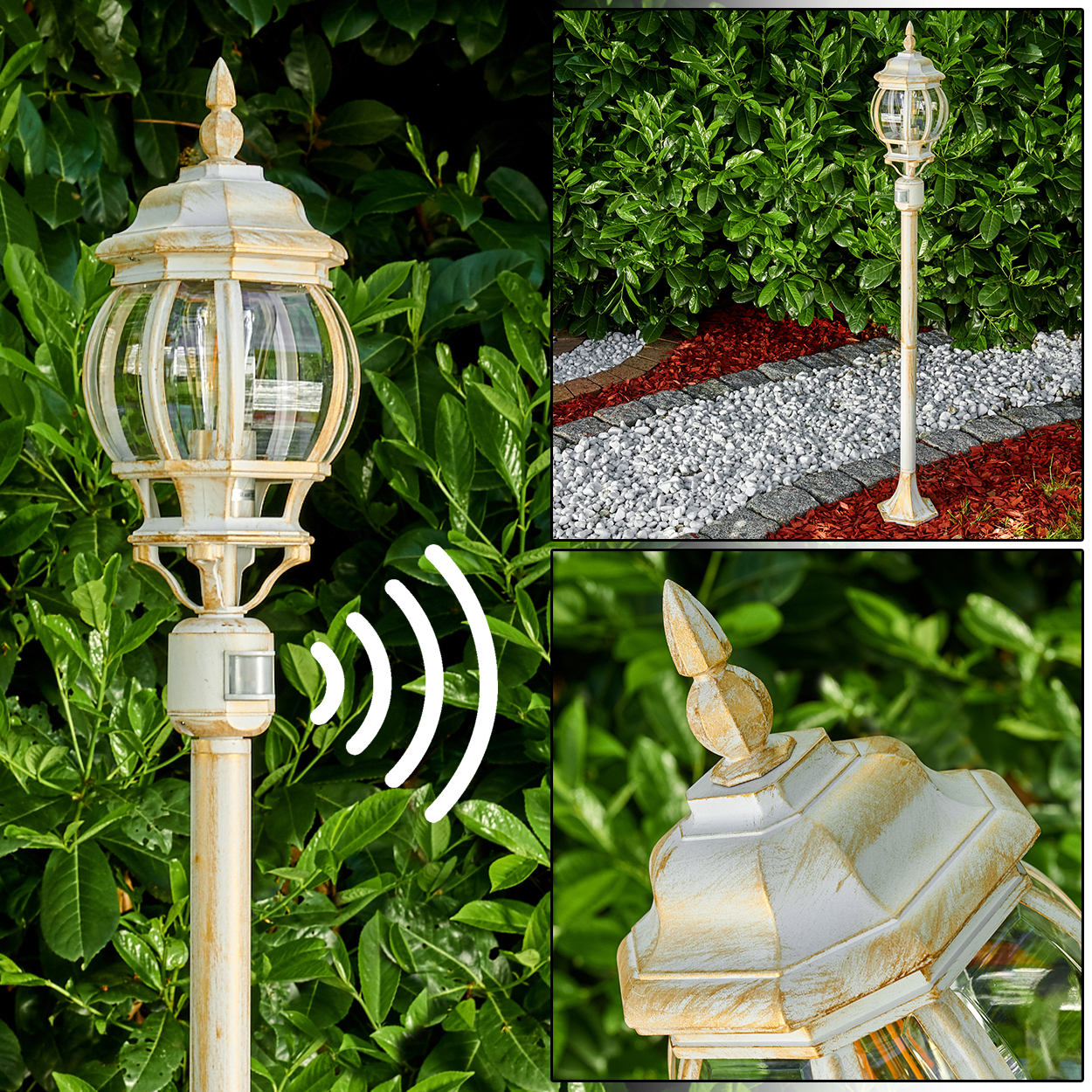 Weiße Außenlampe mit Glasscheiben vor grünem Laub. Im Hintergrund ein Weg mit weißen Steinen und roter Mulche.