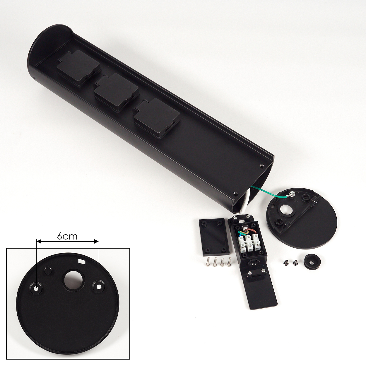Schwarze elektrische Komponente. Teile umfassen ein langes rechteckiges Gehäuse mit Steckdosen, eine kreisförmige Basis und verschiedene kleinere Schrauben und Komponenten.
