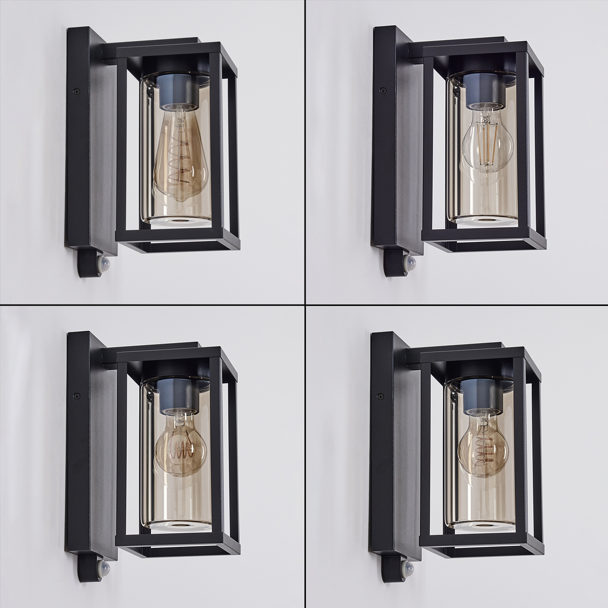Vier schwarze Wandlampen mit Glasschirmen und sichtbaren Glühbirnen an einer weißen Wand. Jede Lampe hat einen rechteckigen Rahmen.