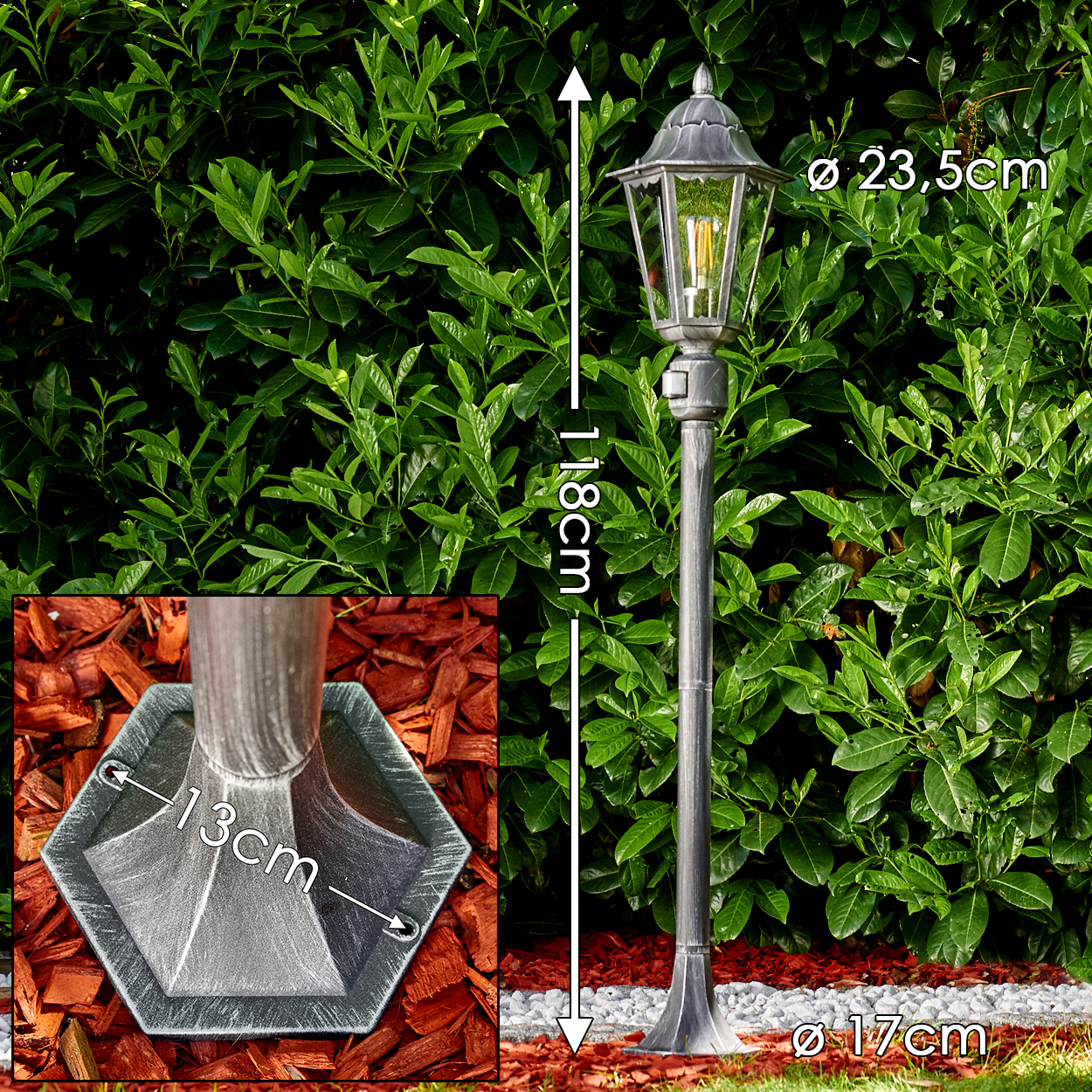 Eine graue Laterne mit Glaskopf, in einem Garten mit grünem Buschhintergrund. Maße sind angegeben.