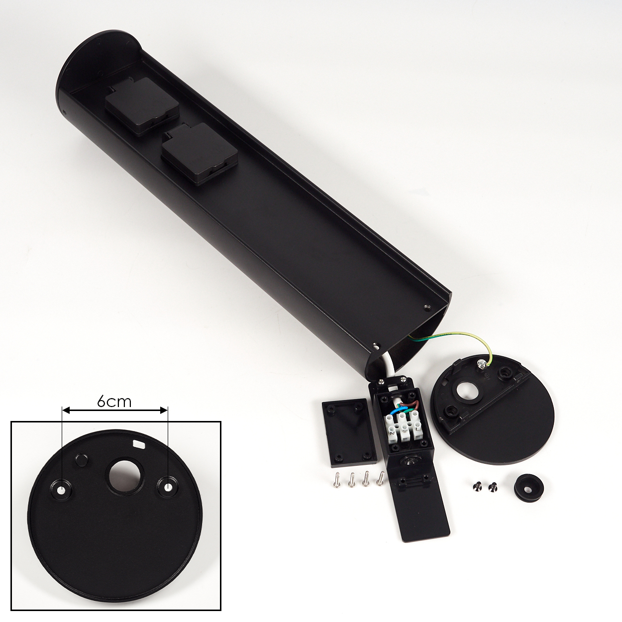 Schwarze elektrische Komponente zerlegt auf Weiß. Enthält ein langes Gehäuse, Endkappen und Verdrahtungskomponenten, Schrauben und eine 6-cm-Messung.