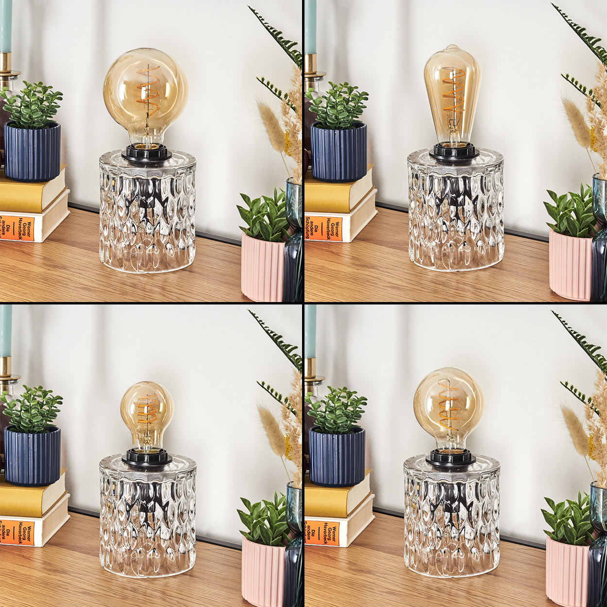 Eine Lampe mit einem durchsichtigen Glassockel und einer Glühbirne steht auf einer Holzoberfläche. Kleine Pflanzen und Bücher sind an den Seiten.
