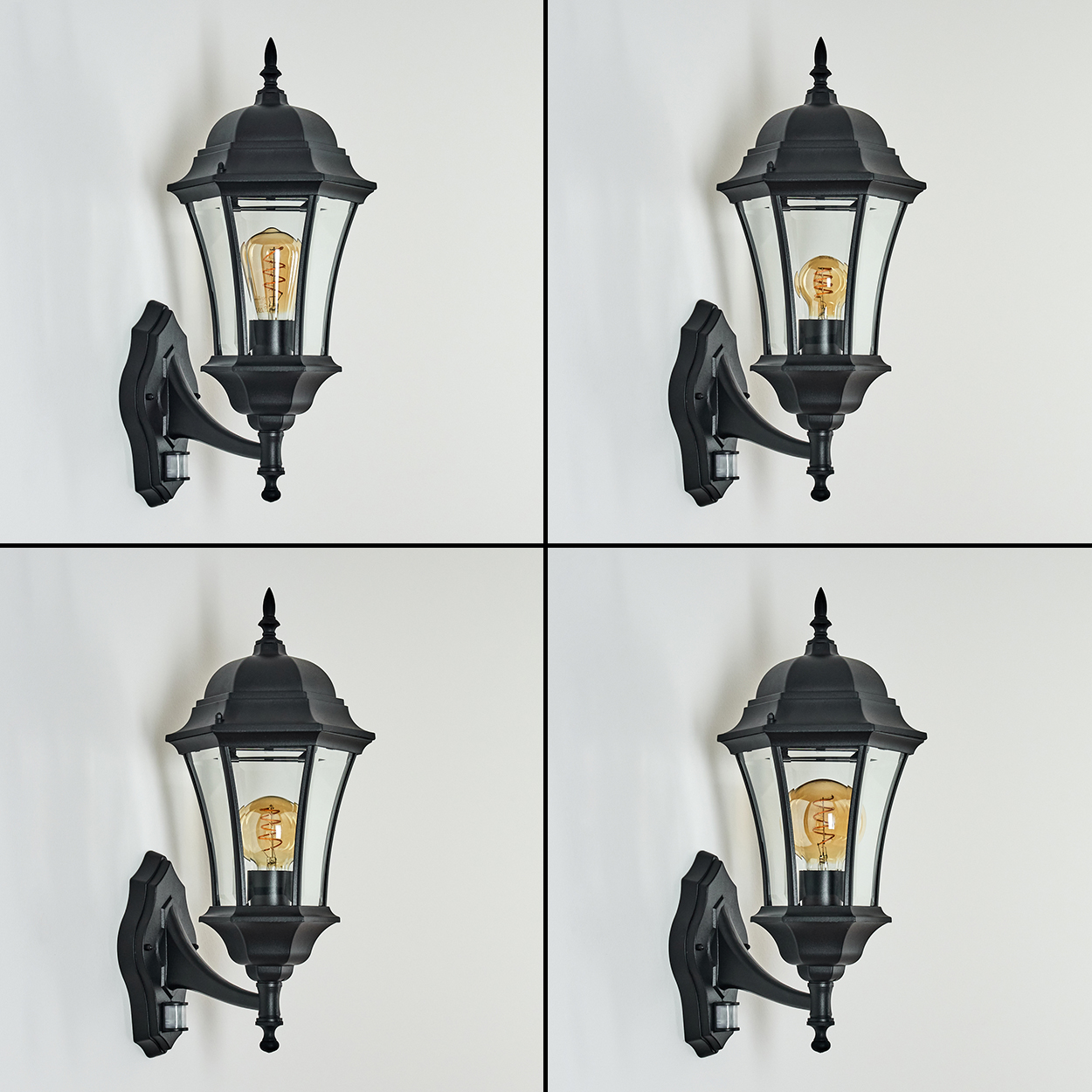Vier schwarze Außenlampen an einer weißen Wand. Jede Lampe hat Glasscheiben und eine Glühbirne. Die Lampen haben Bewegungssensoren.