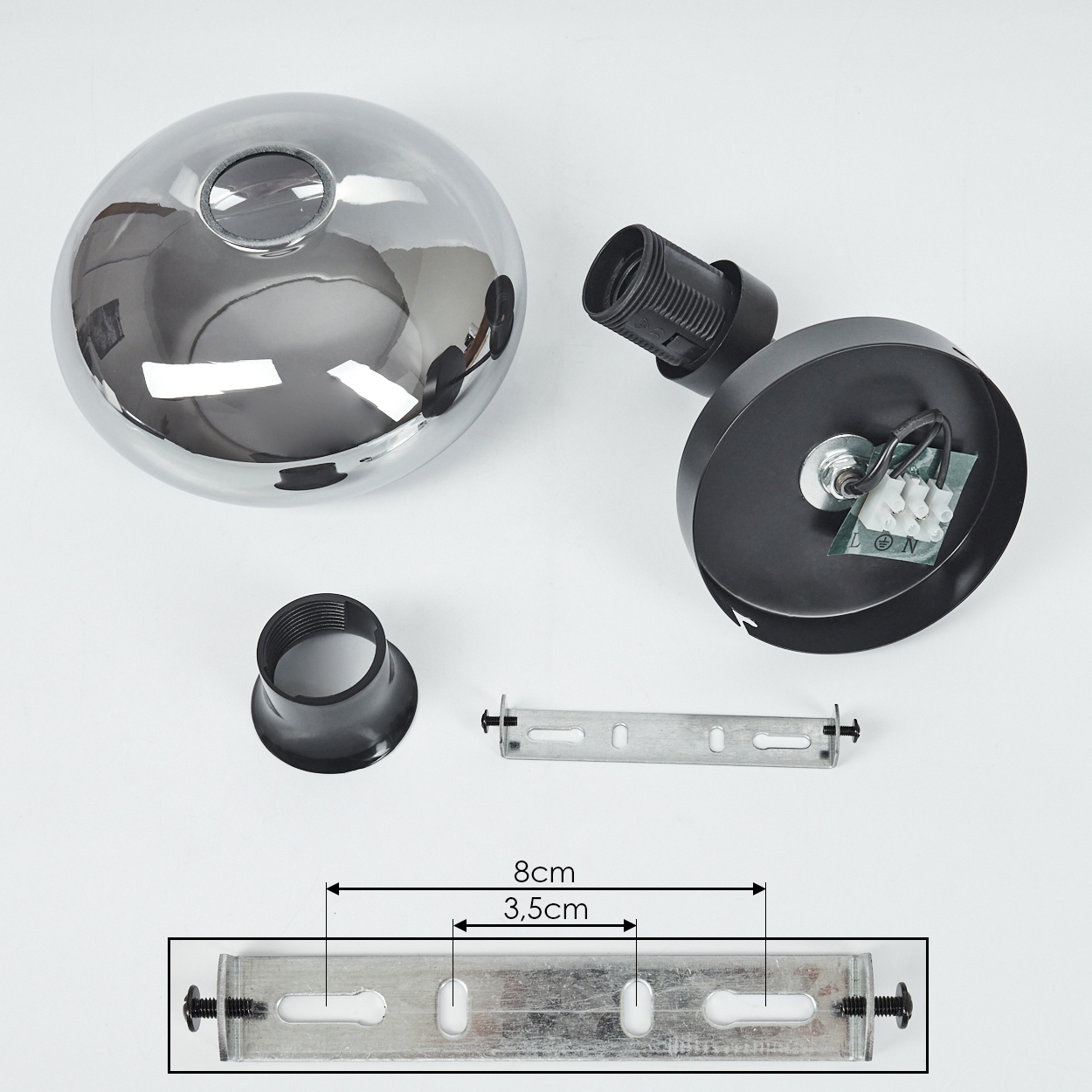 Komponenten einer Lampe: verchromte Kuppel, schwarze Halterung, Fassung, Montagehalterung und schwarzer Ring, mit Messungen.