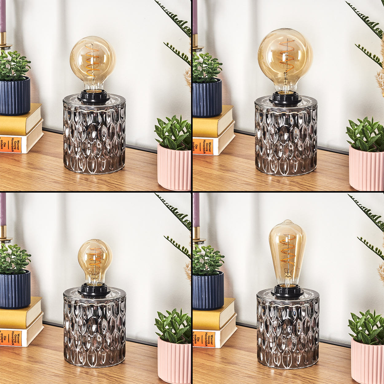 Eine Lampe mit einer Glühbirne mit Spiralfaden steht auf einer Holzoberfläche. Daneben stehen Topfpflanzen und Bücher. Der Hintergrund ist eine weiße Wand.