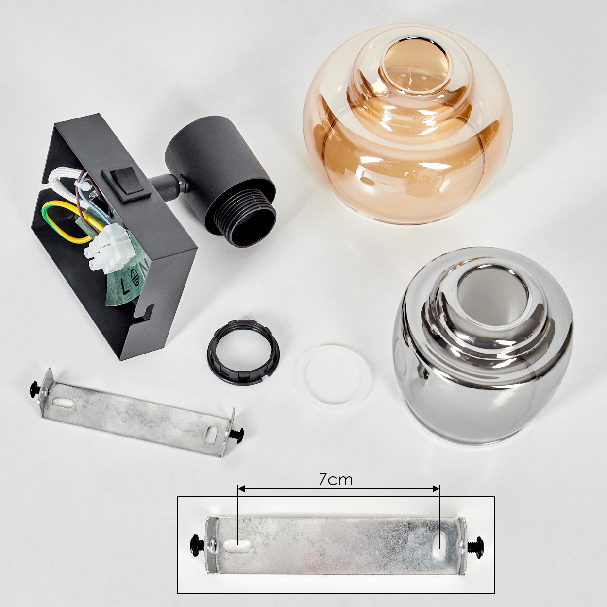 Komponenten einer Lampe sind auf einer weißen Oberfläche angeordnet. Enthält eine schwarze Metallhalterung, eine Glühbirne und diverse Teile.