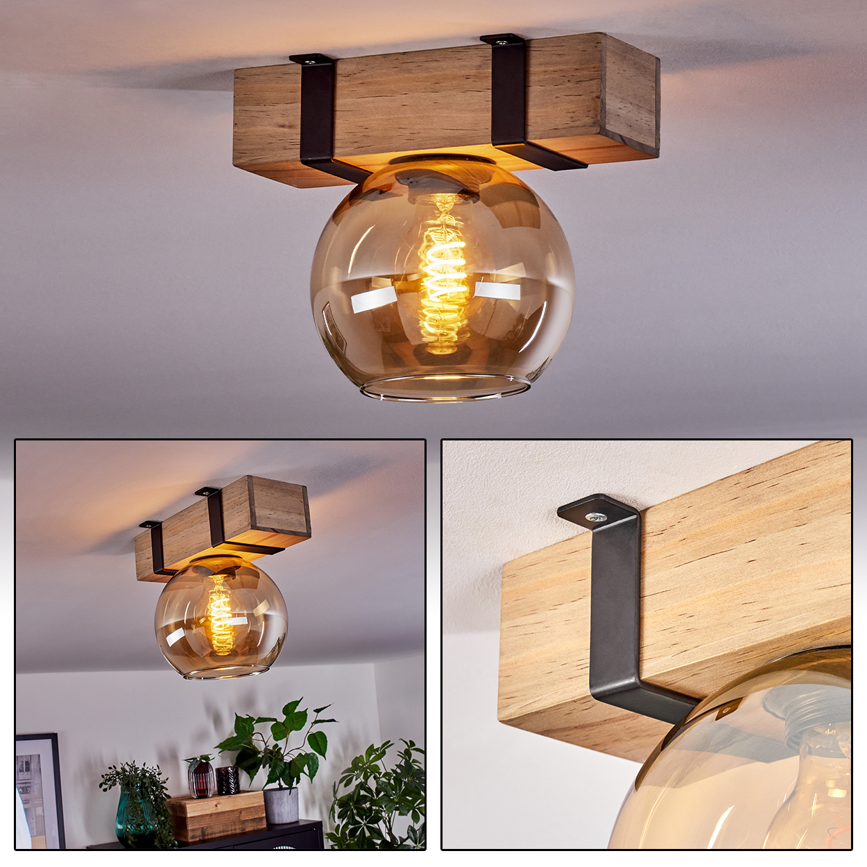 Eine Deckenleuchte mit Holzbalken und einer kugelförmigen, bernsteinfarbenen Glaskugel. Schwarze Metallhalterungen halten sie. Im Inneren leuchtet eine Glühbirne.