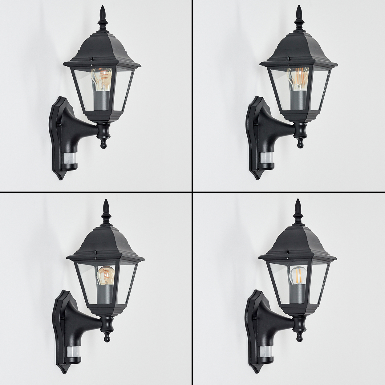 Vier schwarze Außenwandlampen. Jede hat Glasscheiben, einen schwarzen Rahmen und eine Glühbirne. Sie sind an einer weißen Wand montiert.