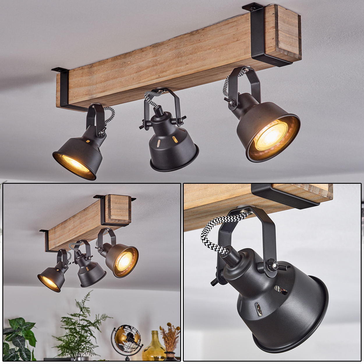 Holzbalken mit drei schwarzen Strahlern. Die Lichter sind an. Die Decke ist weiß. Der Hintergrund hat Pflanzen und Dekoration.