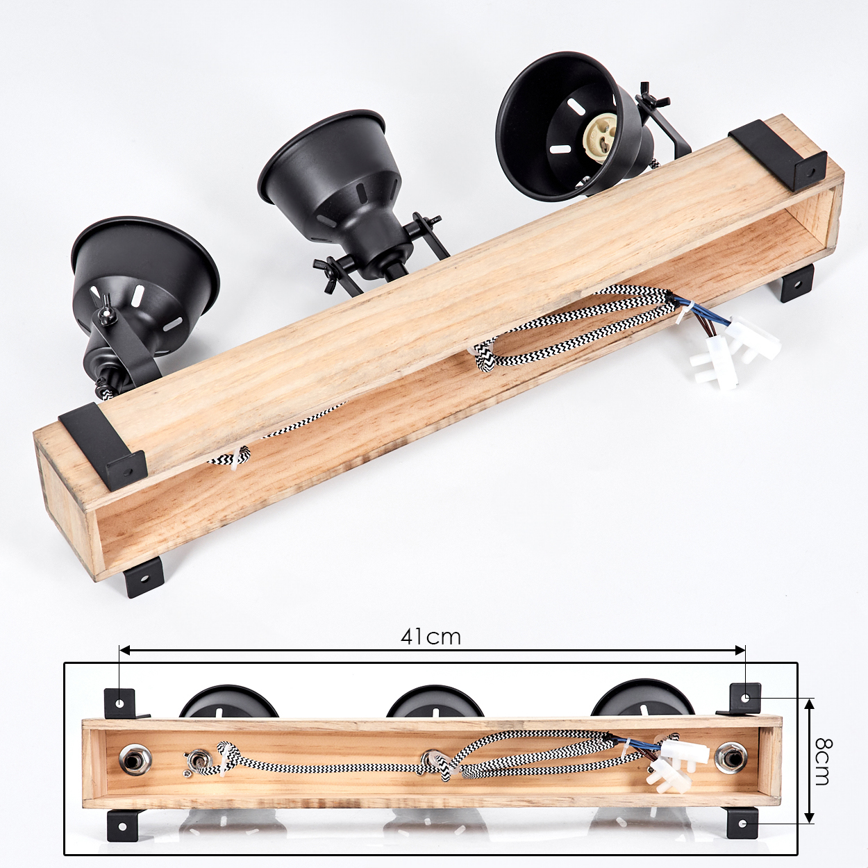 Holzlampe mit drei schwarzen Strahlern. Die Lampe hat einen Holzrahmen, und das schwarz-weiße Kabel ist sichtbar.