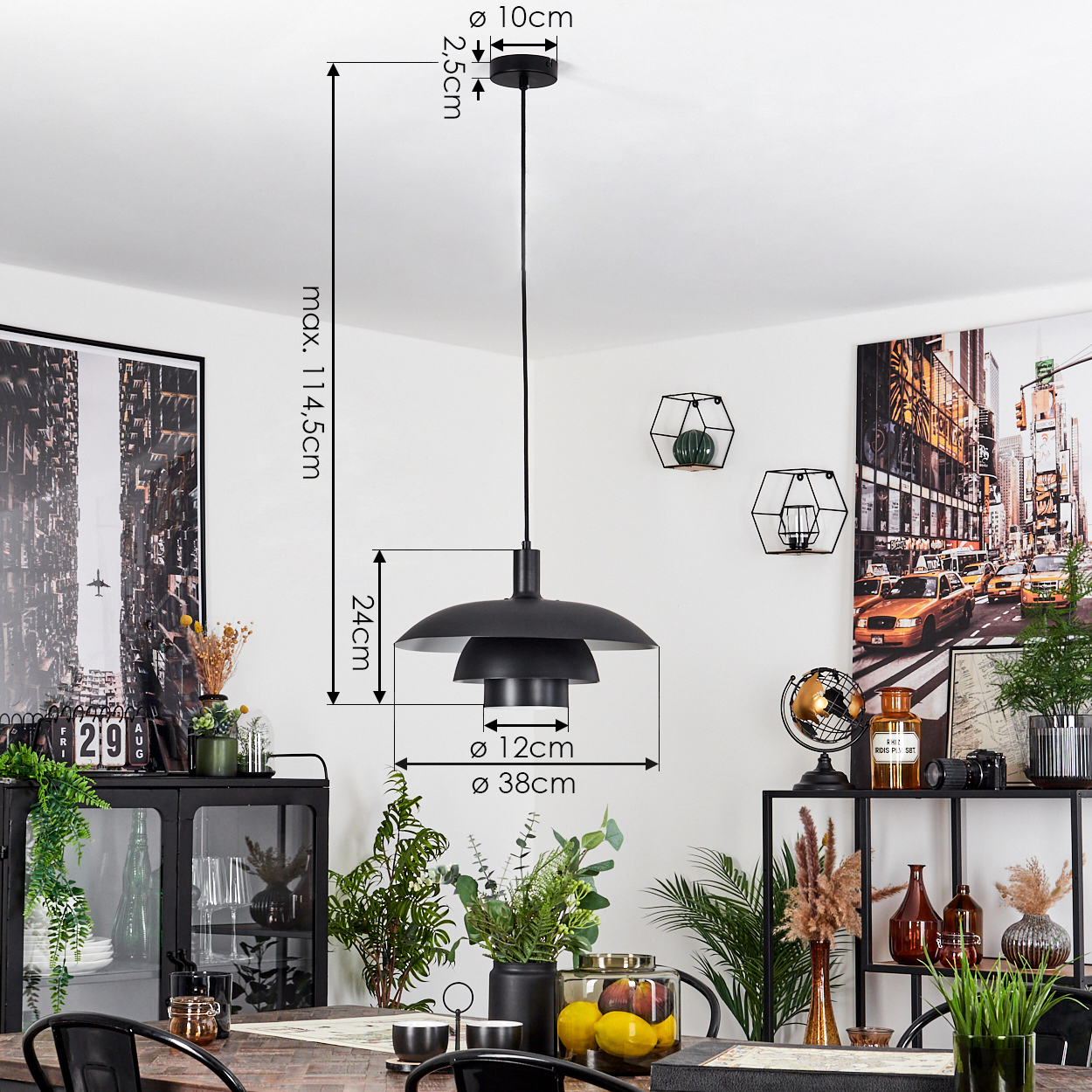 Eine schwarze Pendelleuchte hängt über einem Holztisch. Der Raum hat Gemälde und Pflanzen. Abmessungen sind an der Lampe angegeben.