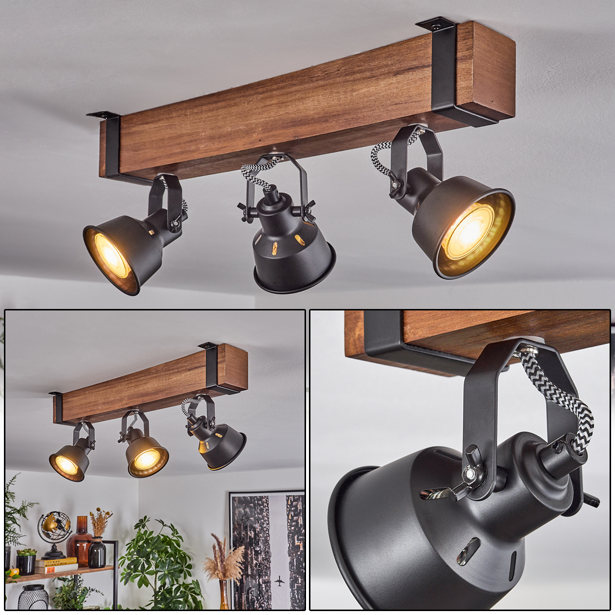 Deckenleuchte mit 3 schwarzen Strahlern an einem Holzbalken. Die Lichter sind an und beleuchten den Raum. Die Decke ist weiß.