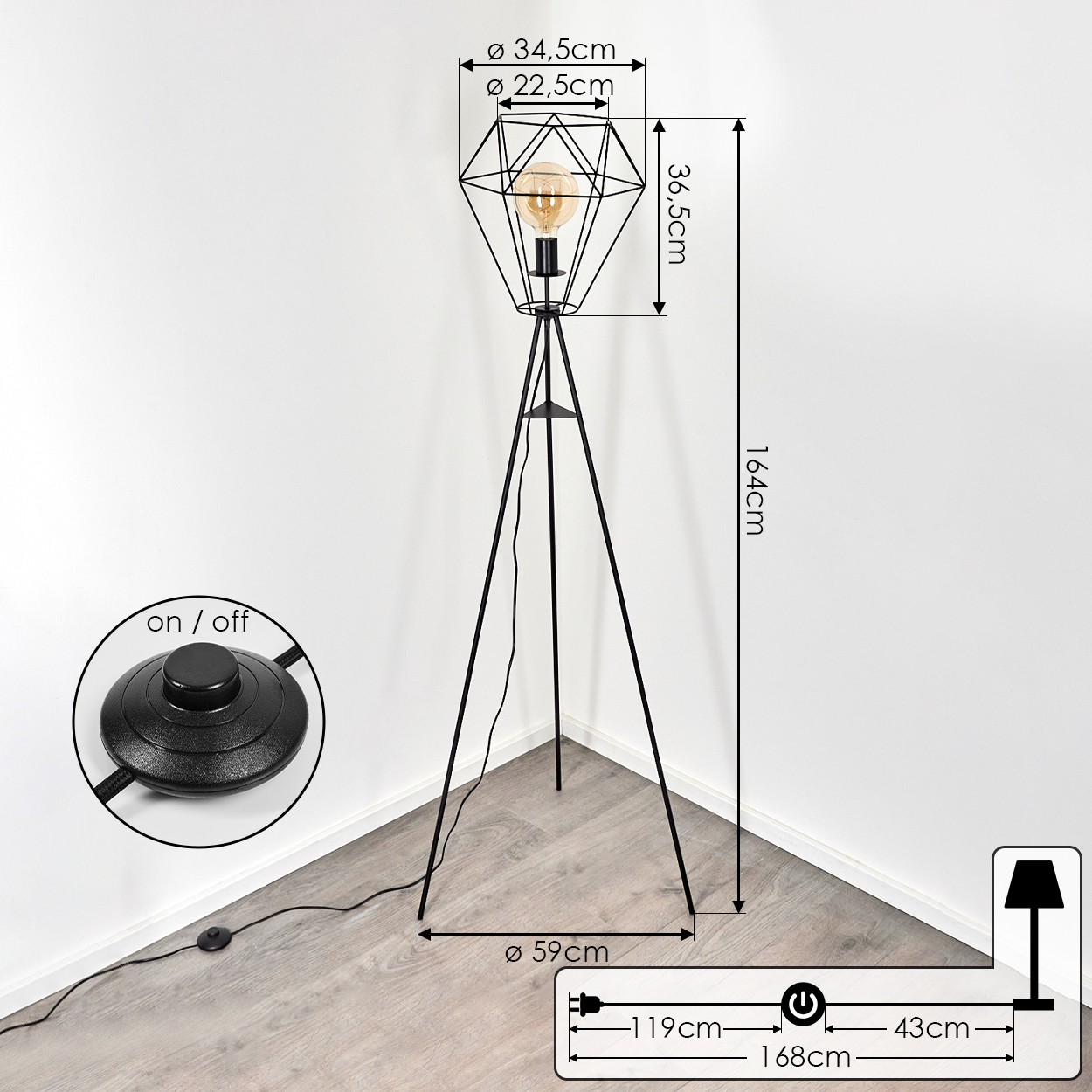Eine schwarze, geometrische Stehlampe mit Glühbirne, Fußschalter und Maßen. Die Lampe steht in einer Ecke, neben der Wand.