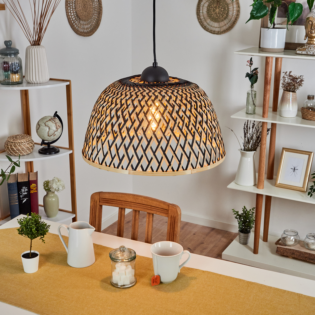 Esszimmer-Szene mit gewebter Lampe, Tischdekoration und Regalen mit Dekoration. Gelber Läufer, weißer Krug und Teetasse auf dem Tisch.