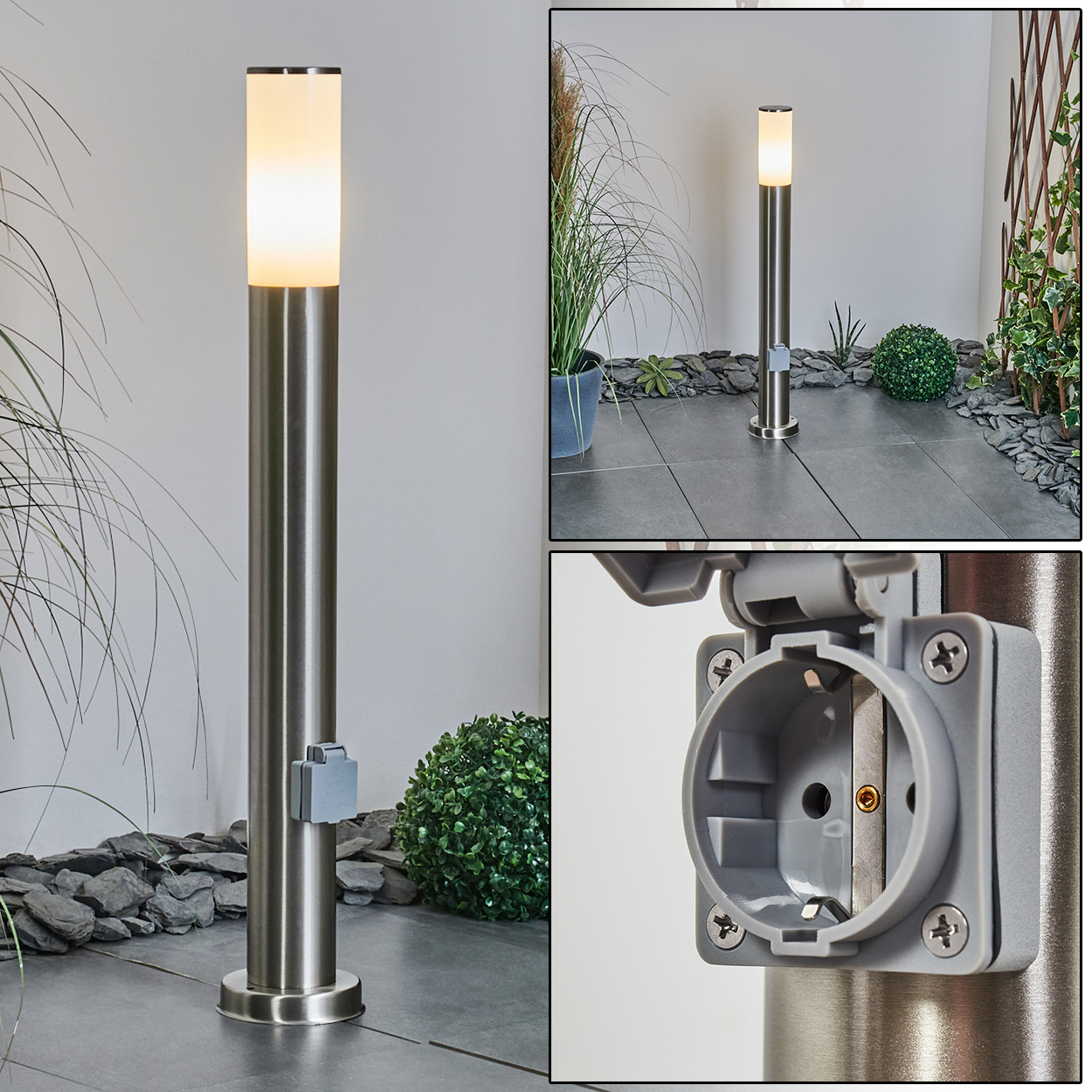 Eine silberne Außenlampe mit leuchtendem Oberteil und eingebauter Steckdose. Sie steht auf einer gefliesten Terrasse, mit Pflanzen im Hintergrund.