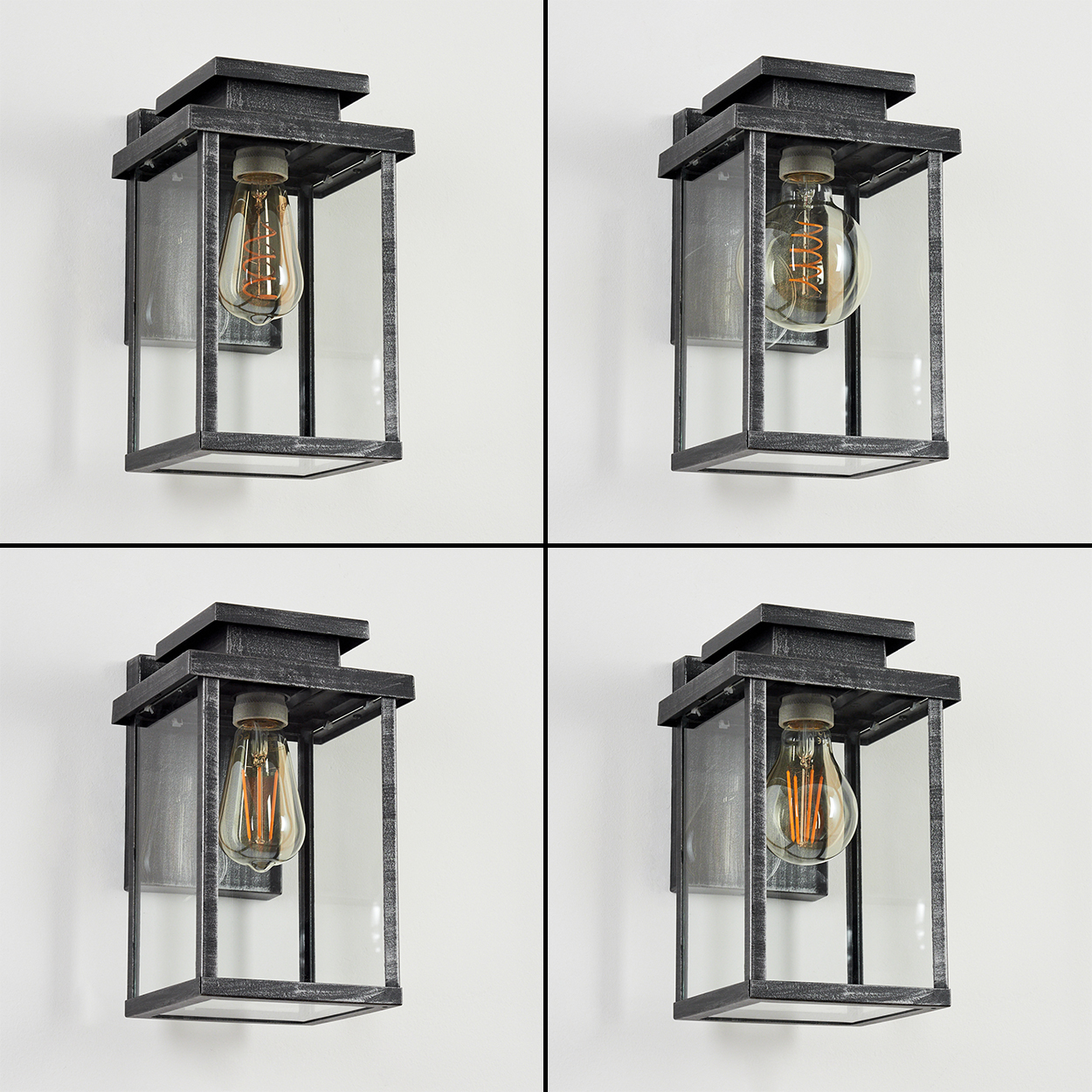 Vier an der Wand befestigte Außenlampen. Jede hat einen dunkelgrauen Metallrahmen und ein Glasgehäuse mit dekorativer Glühbirne.