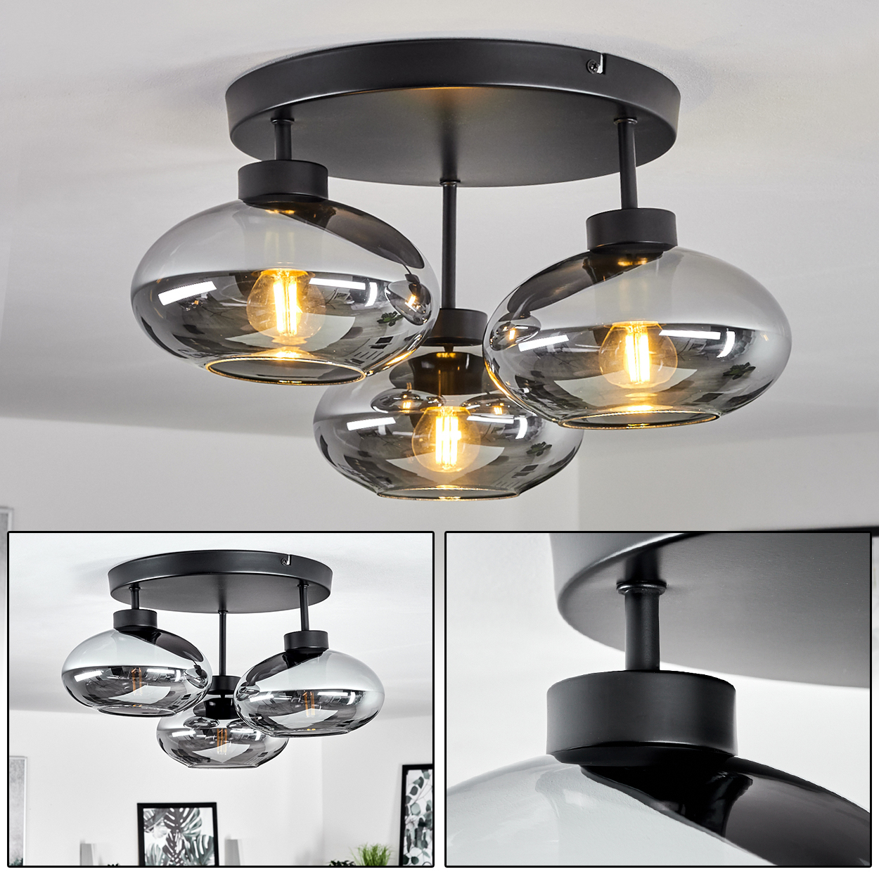 Eine schwarze Deckenlampe mit drei grauen Glasschirmen, die jeweils eine leuchtende Glühbirne enthalten. Die Lampe ist an einer weißen Decke.