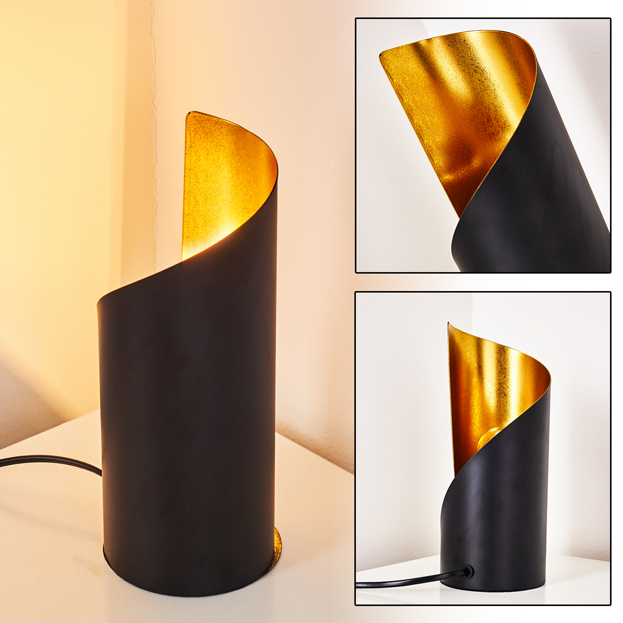 Eine schwarz-goldene Tischlampe. Die Lampe ist zylindrisch mit gewölbter Oberseite. Sie steht auf einer weißen Oberfläche vor einer Wand.