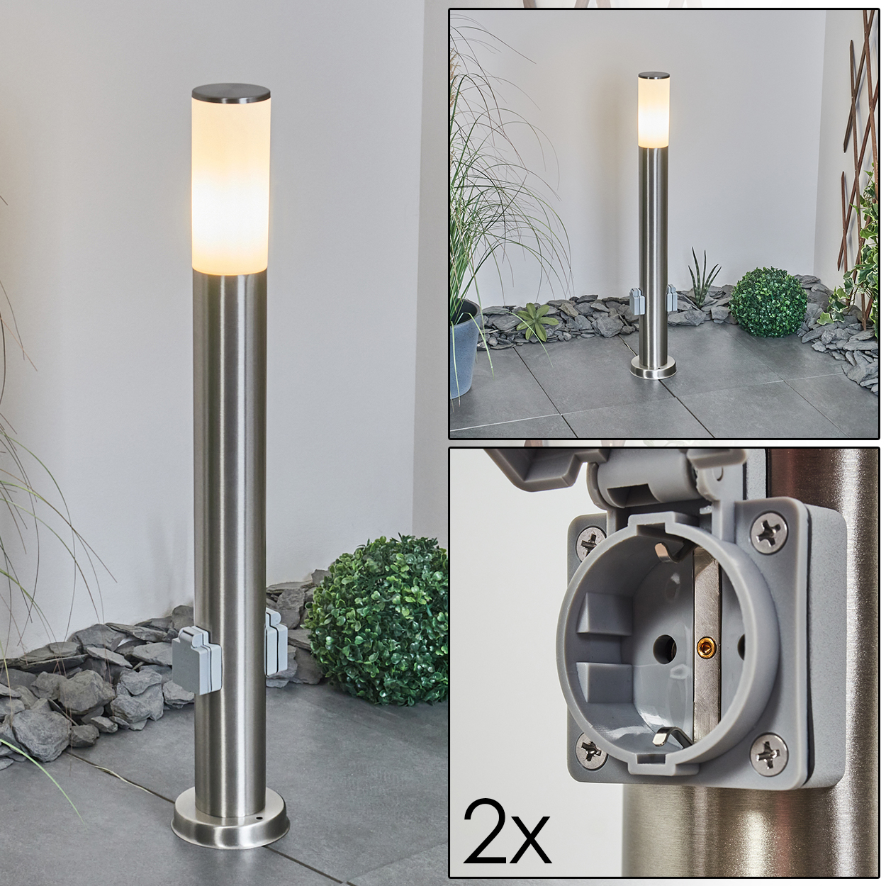 Eine Edelstahl-Außenlampe mit Licht oben. Sie hat eine Steckdose. Der Hintergrund zeigt Pflanzen und einen gepflasterten Bereich.