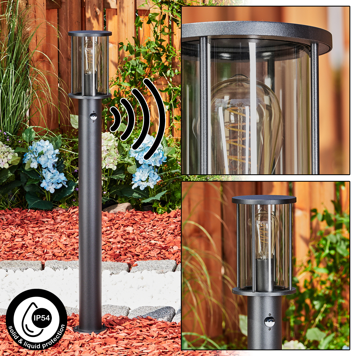 Eine schwarze Außenlampe mit Glasabdeckung. Sie steht in einem Garten mit Blumen und einem Holzzaun im Hintergrund.