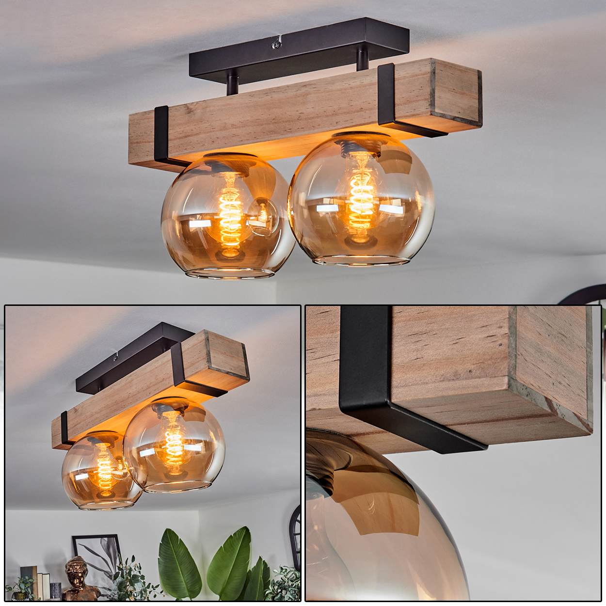 Eine Deckenleuchte aus Holz mit zwei Glaskugeln, die leuchtende Glühbirnen enthalten. Die Leuchte hat einen schwarzen Metallrahmen.
