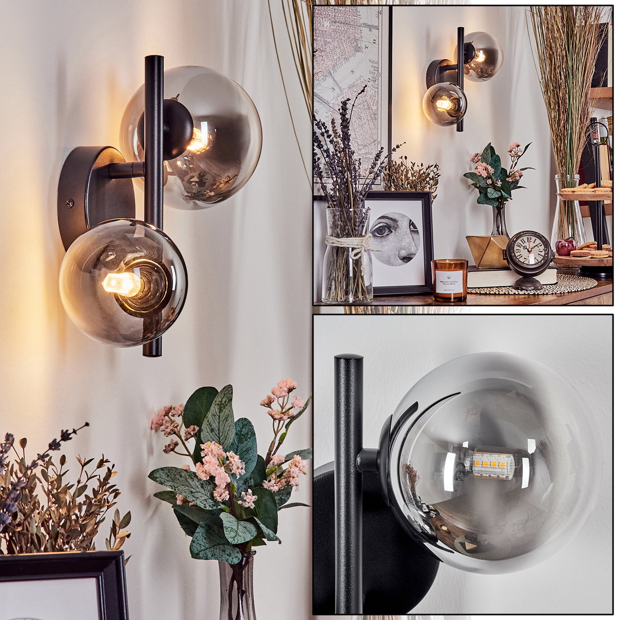 Eine Wandlampe mit zwei Glaskugeln und schwarzer Halterung ist an einer weißen Wand montiert. Weitere Dekorationen sind zu sehen.