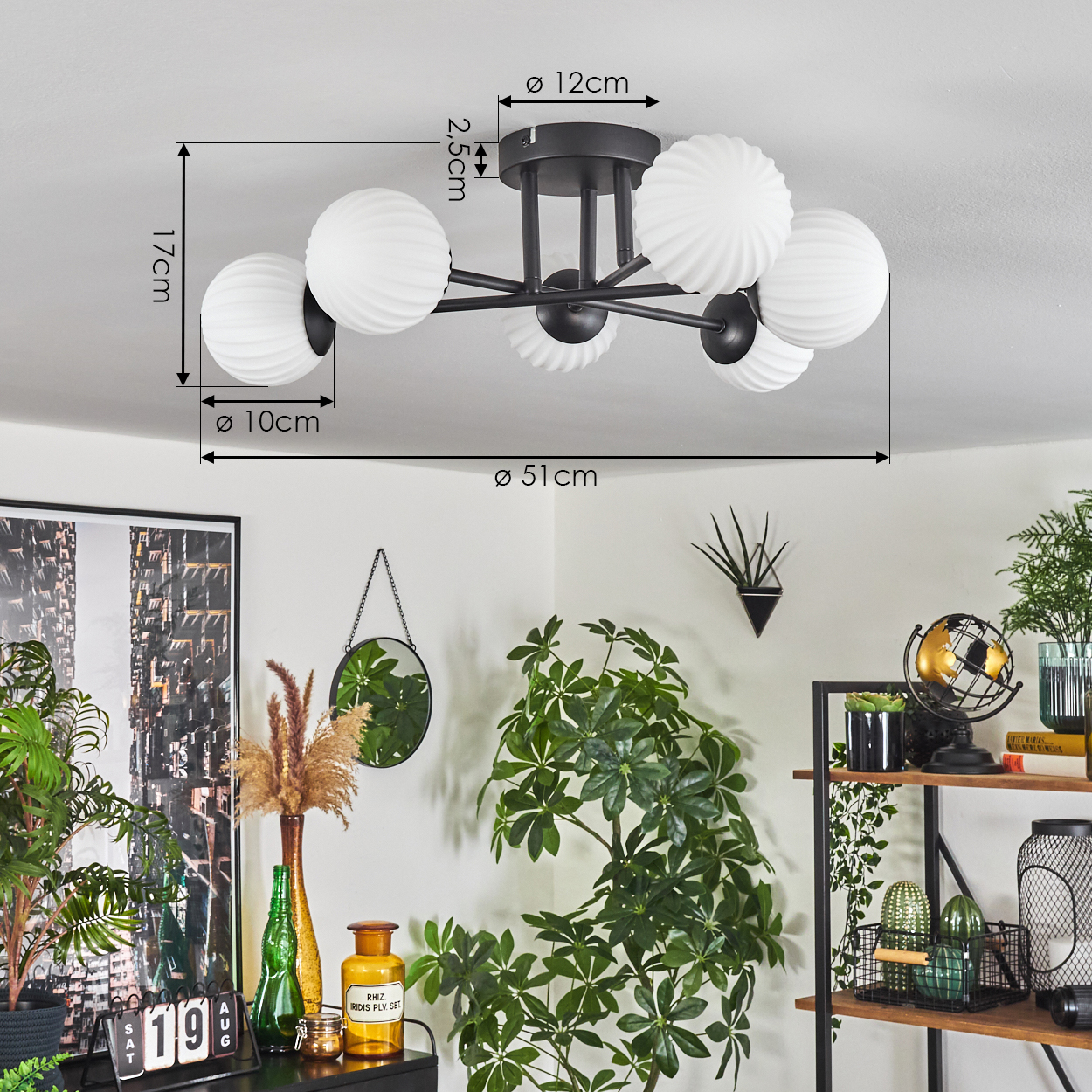 Deckenlampe mit weißen, kugelförmigen Lichtern. Darunter ein Raum mit Pflanzen, einem Spiegel und einem Regal mit Dekorationen.