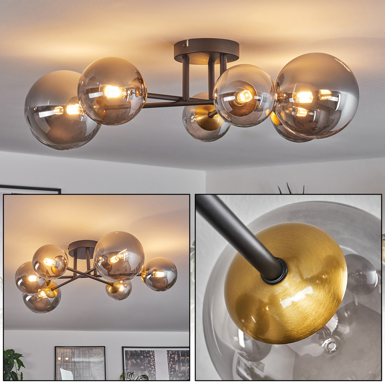 Moderne Deckenleuchte mit grauen Glaskugeln, goldenen Akzenten und schwarzen Metallarmen. Das Licht ist an.