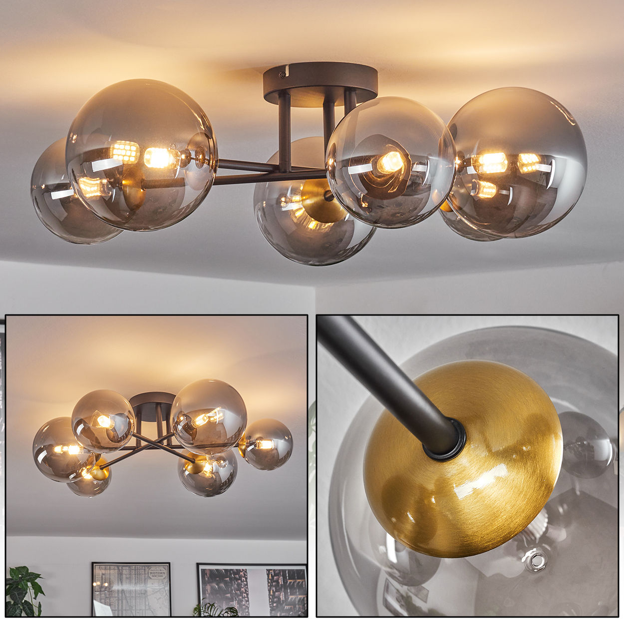 Eine moderne Deckenleuchte mit mehreren rauchigen Glaskugeln, die an schwarzen Metallarmen befestigt sind, mit einem goldenen Akzent. Das Licht ist an.