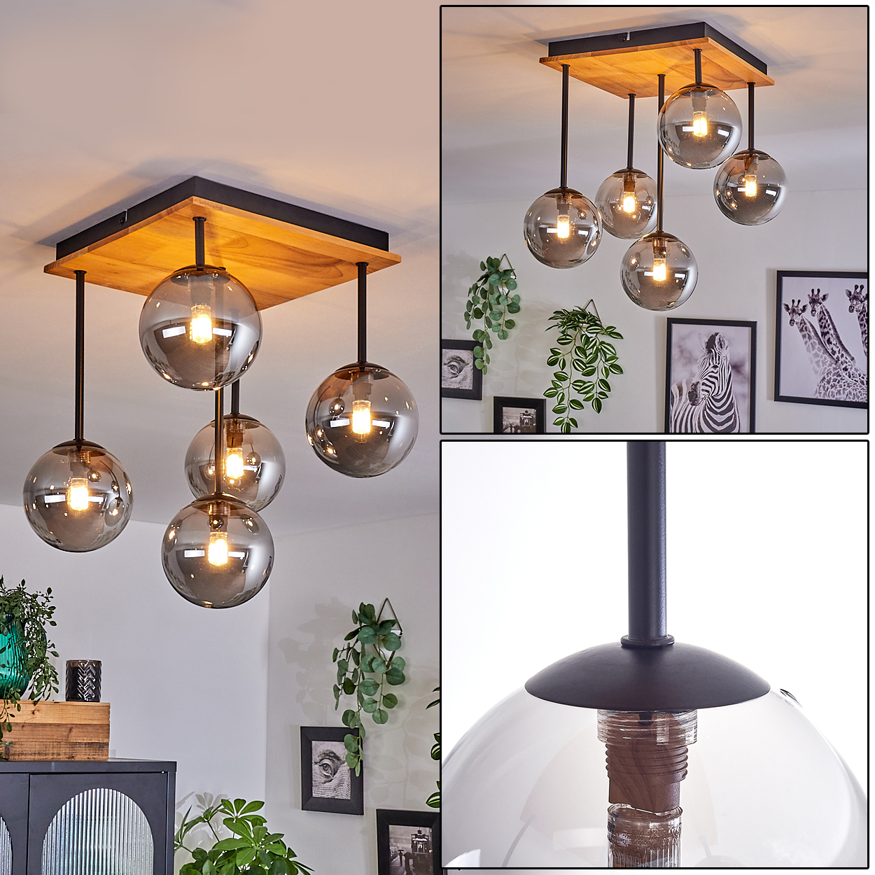 Moderne Hängeleuchte mit sechs rauchfarbenen Glaskugeln, Holzsockel, schwarzen Stäben und warmer Beleuchtung. Der Hintergrund zeigt gerahmte Kunst und Pflanzen.