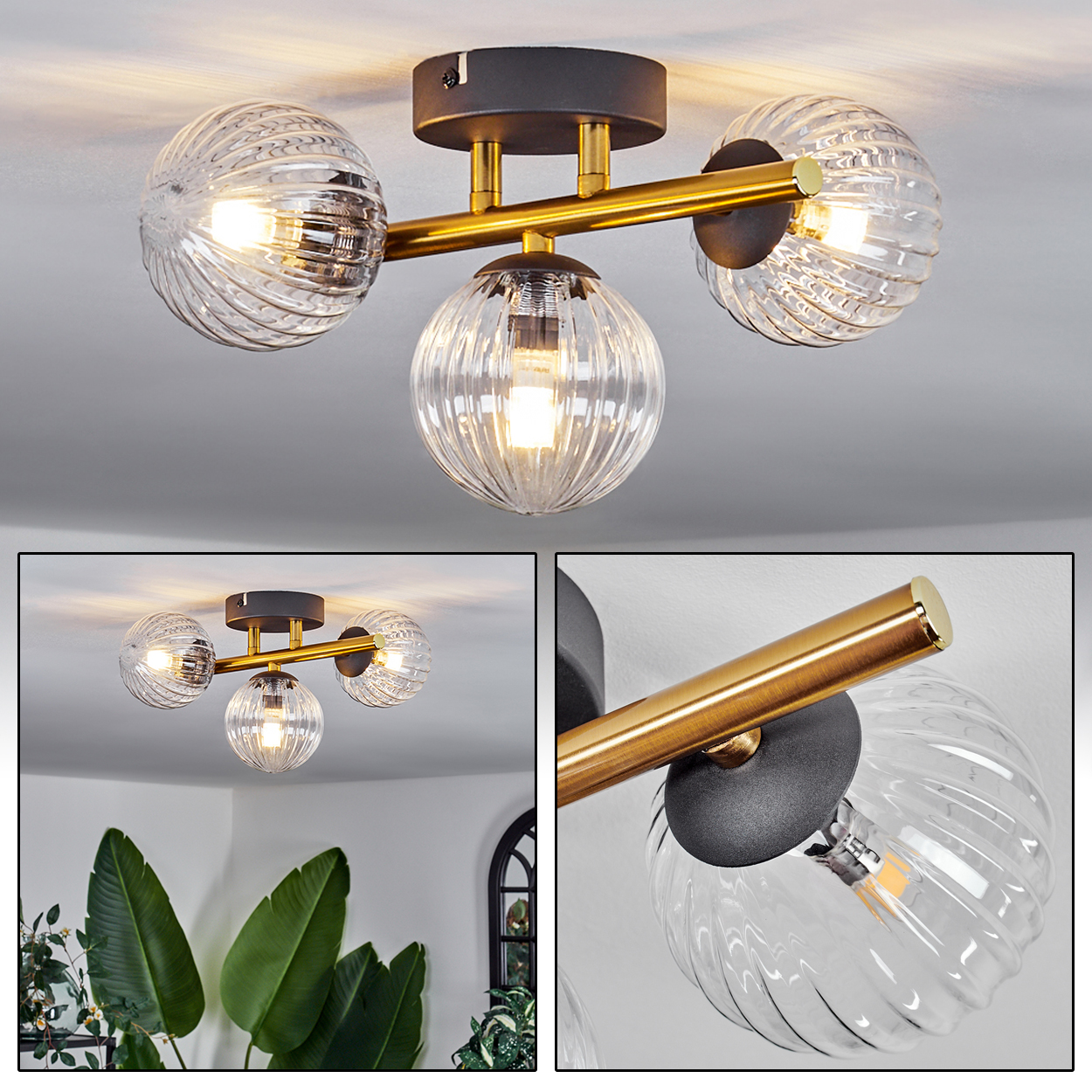 Moderne Deckenlampe mit drei Glaskugeln, goldenen Akzenten und dunkelgrauem Sockel. Das Licht ist an.
