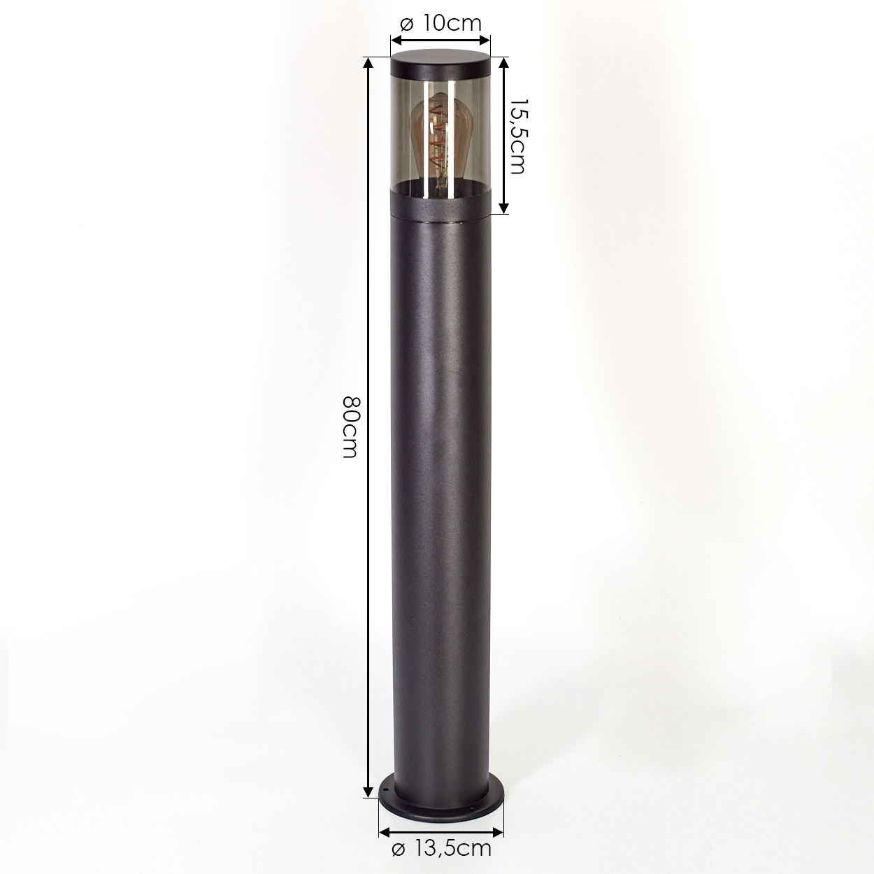 Eine schwarze, zylindrische Außenlampe mit beschrifteten Abmessungen. Sie hat eine Glühbirne in einer Glasabdeckung und einen Sockel.