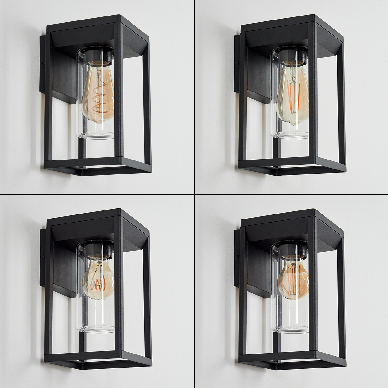 Vier identische schwarze, rechteckige Außenwandleuchten mit Glasröhren und Edison-Glühbirnen, an einer weißen Wand montiert.
