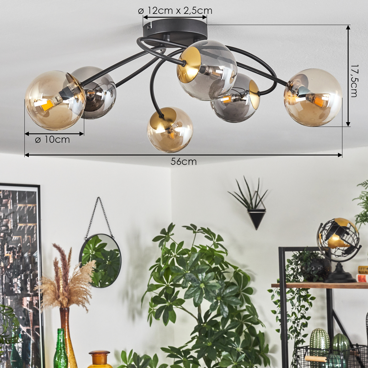 Eine moderne Deckenleuchte mit sechs kugelförmigen Lampen. Die Lampen sind aus Glas mit goldfarbenen Details. Der Hintergrund zeigt Pflanzen und andere Dekorationen.