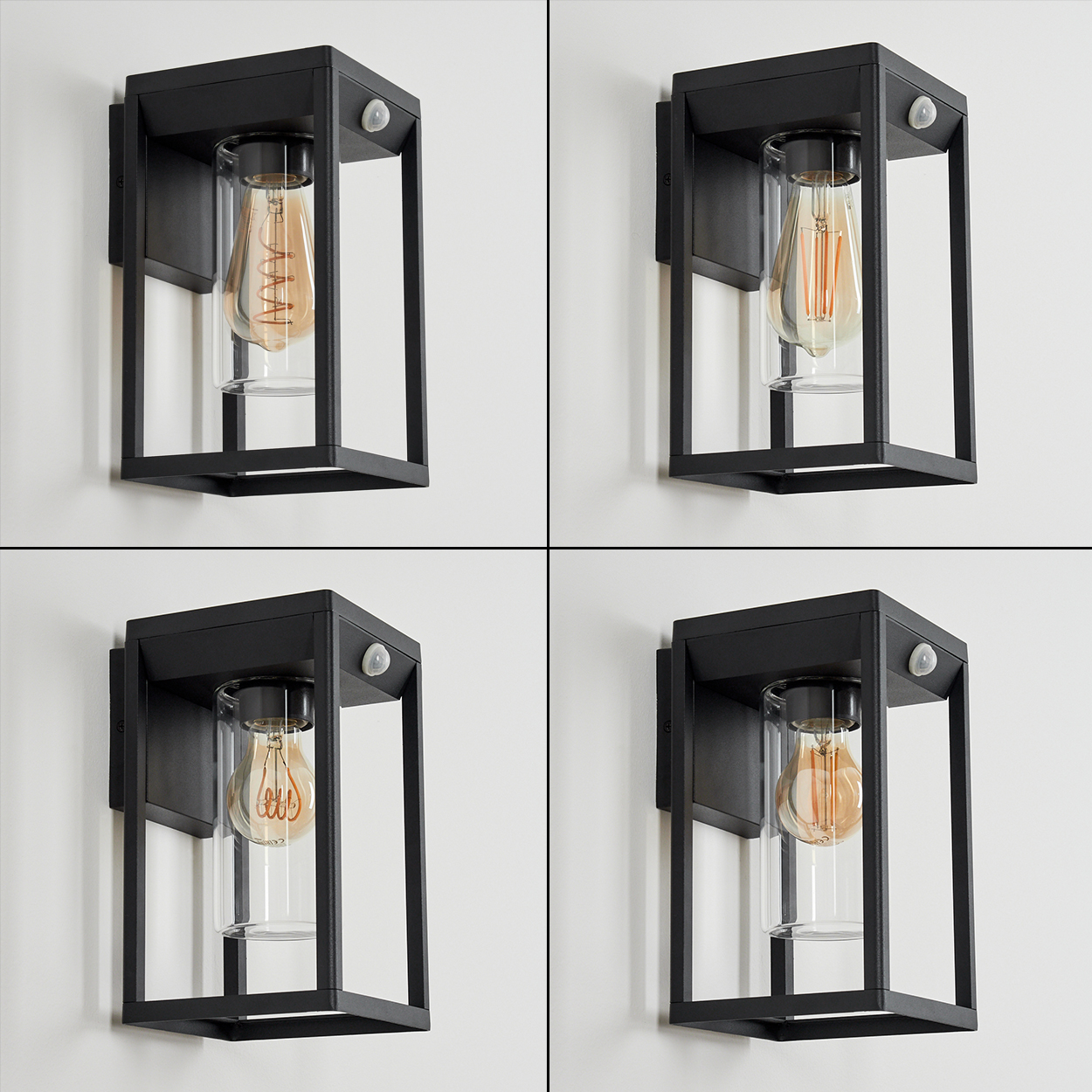 Vier schwarze Wandlampen. Jede hat einen Glaskörper mit einer Glühbirne. Die Lampen sind an einer weißen Wand befestigt.