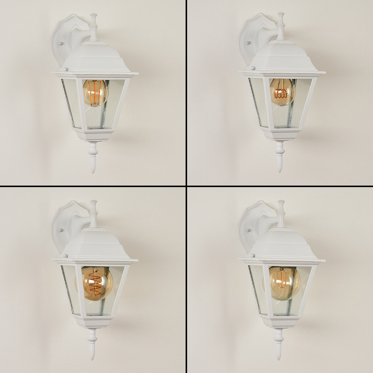Vier weiße Außenlampen. Jede Lampe hat ein Glasgehäuse mit einer warmen Glühbirne, die an einer schlichten Wand befestigt ist.