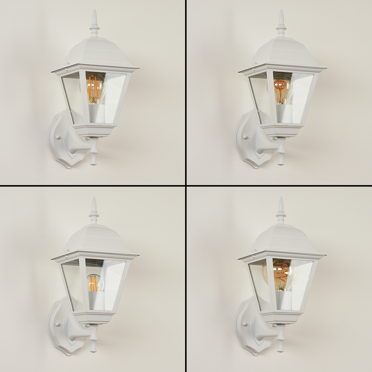 Vier weiße Außenlampen mit Glasscheiben und Glühbirnen sind an einer hellbeigen Wand befestigt. Die Lampen sind identisch.