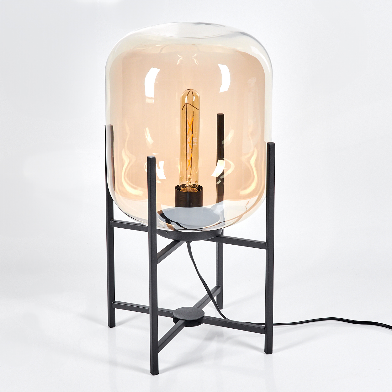 Eine moderne Lampe mit Glasschirm und sichtbarer Glühbirne, getragen von einem schwarzen Metallrahmen auf weißem Untergrund.