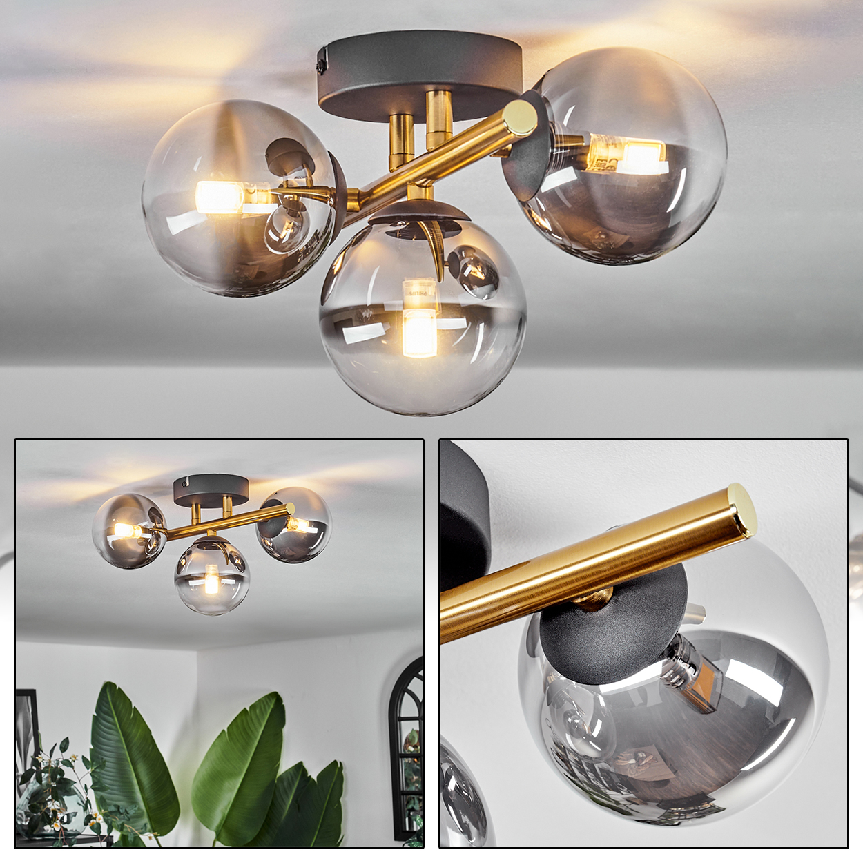 Deckenlampe mit vier Glaskugelschirmen, mit Messingakzenten. Die Glühbirnen sind beleuchtet. Der Hintergrund ist eine weiße Decke.