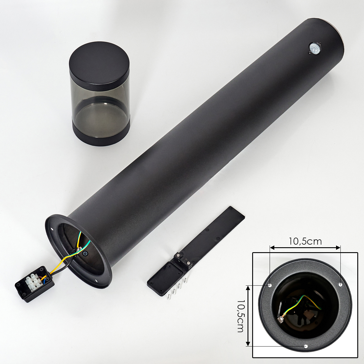 Schwarze zylindrische Lampenteile auf Weiß. Enthält ein langes Rohr, eine Basis mit Drähten, einen kleinen Behälter und ein Diagramm mit Maßen.