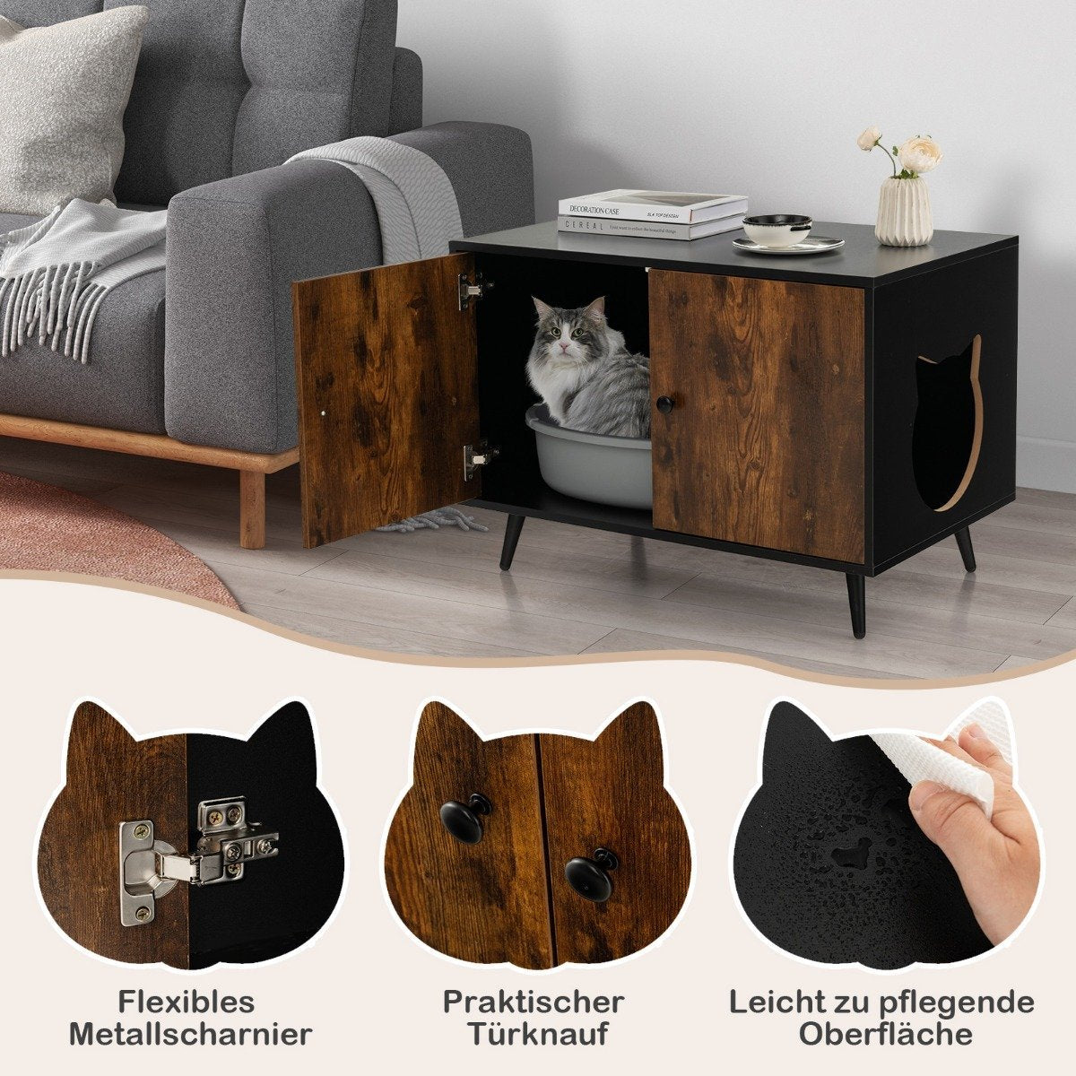 Una casa para gatos negra y marrón con un gato dentro. Tiene una puerta con forma de gato, un gato dentro y un sofá al fondo.