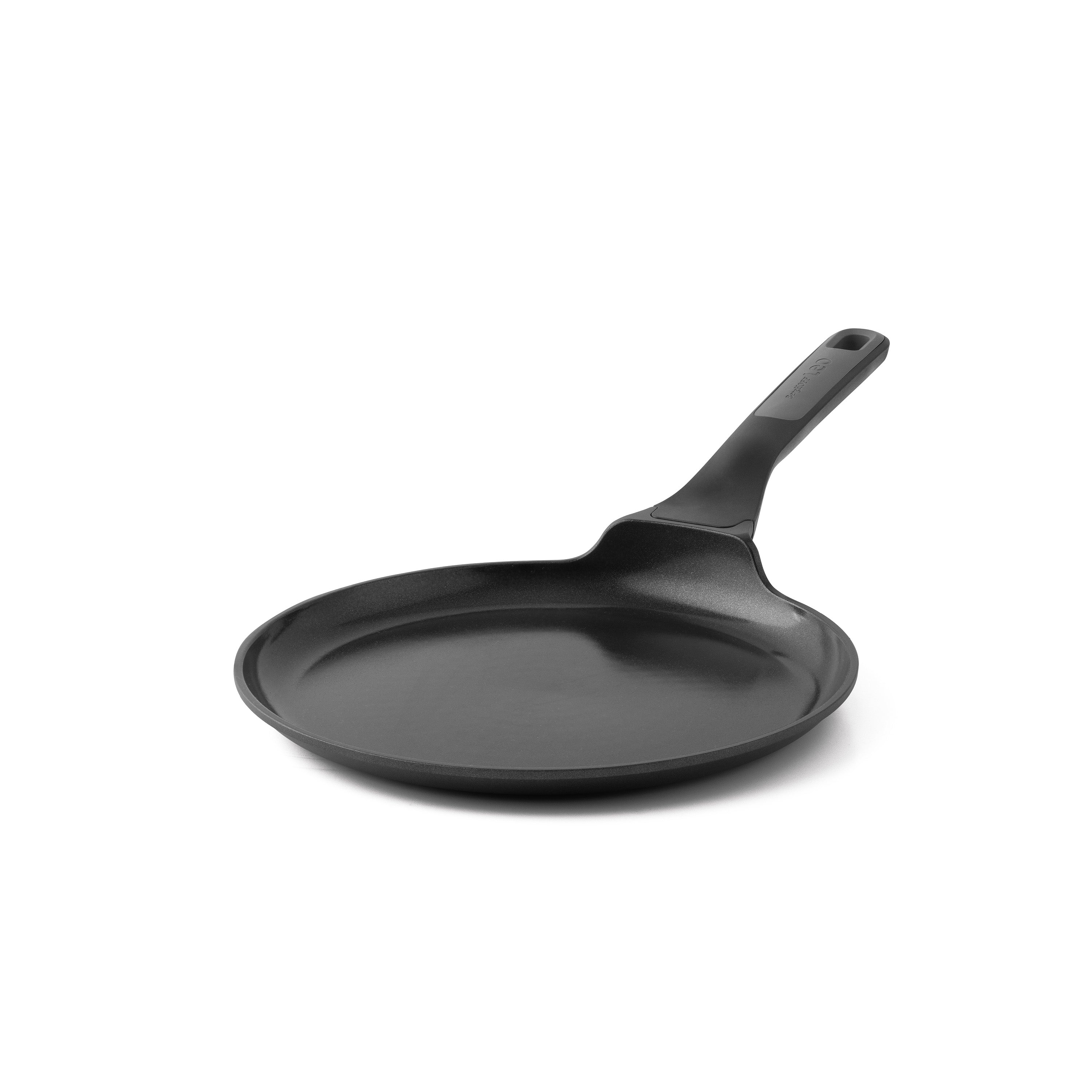 A black pancake pan with a long handle, set against a white background. The pan is angled slightly towards the viewer.