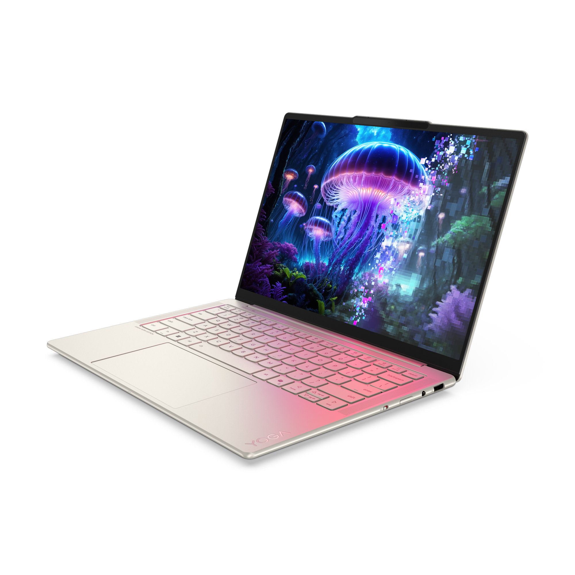 Laptop wyświetla scenę z meduzami. Laptop jest otwarty, pokazując klawiaturę z gradientowym różowym podświetleniem i białym tłem.