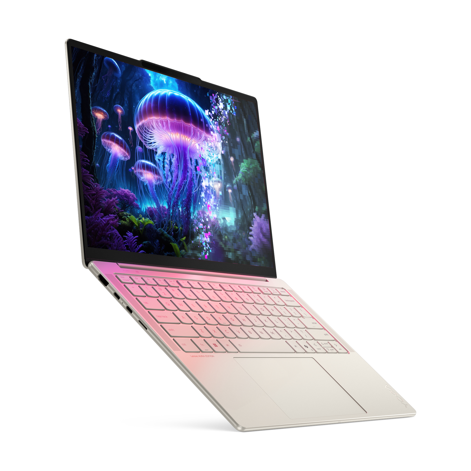 Laptop wyświetla scenę z meduzami. Laptop jest w kolorze złamanej bieli z klawiaturą w różowym gradiencie. Białe tło.