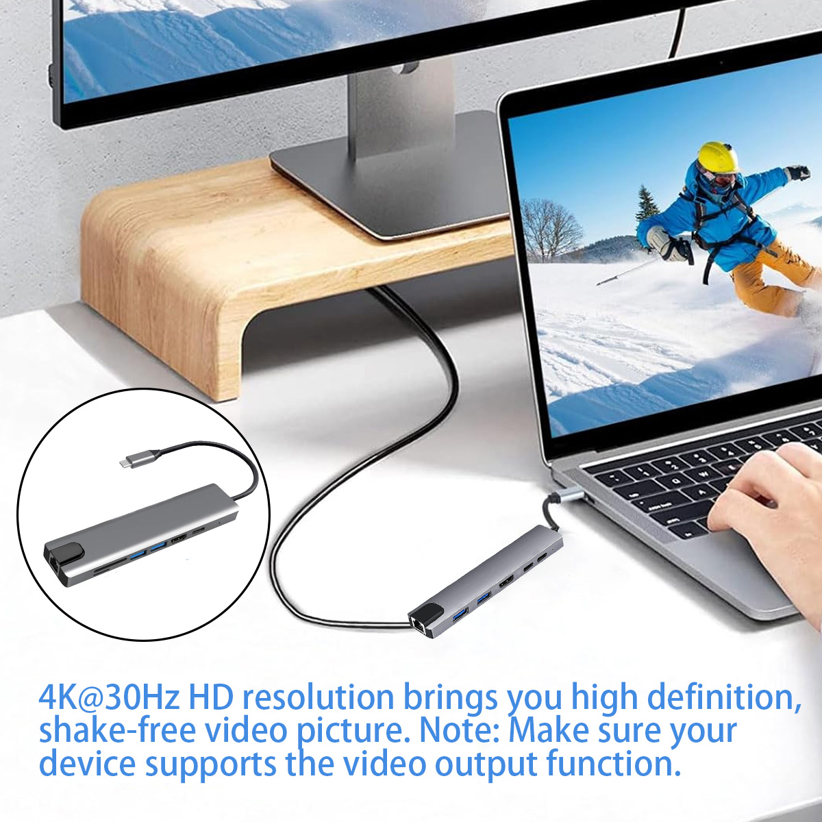 Ein Laptop ist mit einem Hub verbunden. Oben befindet sich ein Monitor und ein Skifahrer auf dem Bildschirm. Der Text lautet 4K-Auflösung.