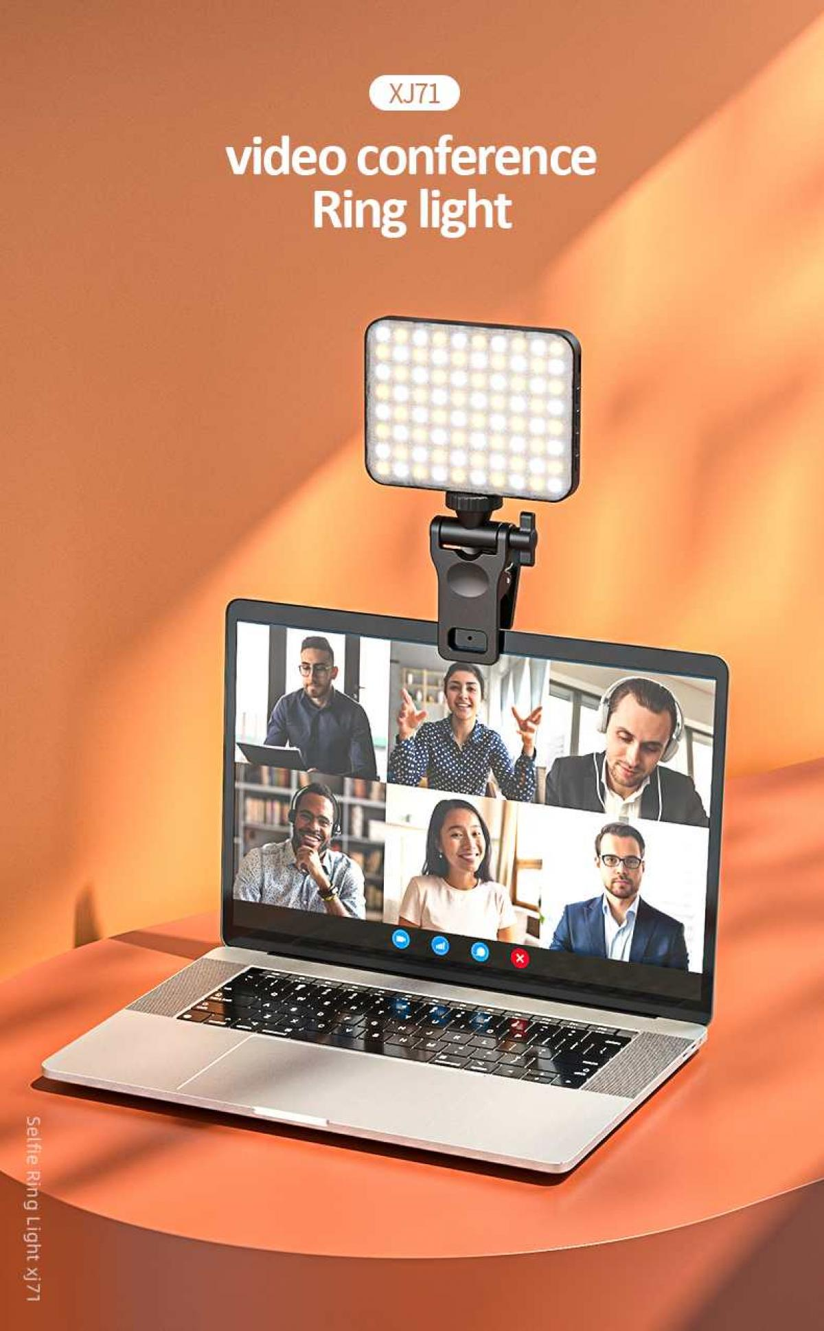 Ringlicht auf einem Laptop, das eine Videokonferenz zeigt. Oranger Hintergrund. Der Laptop zeigt sechs Personen in einem Videoanruf.