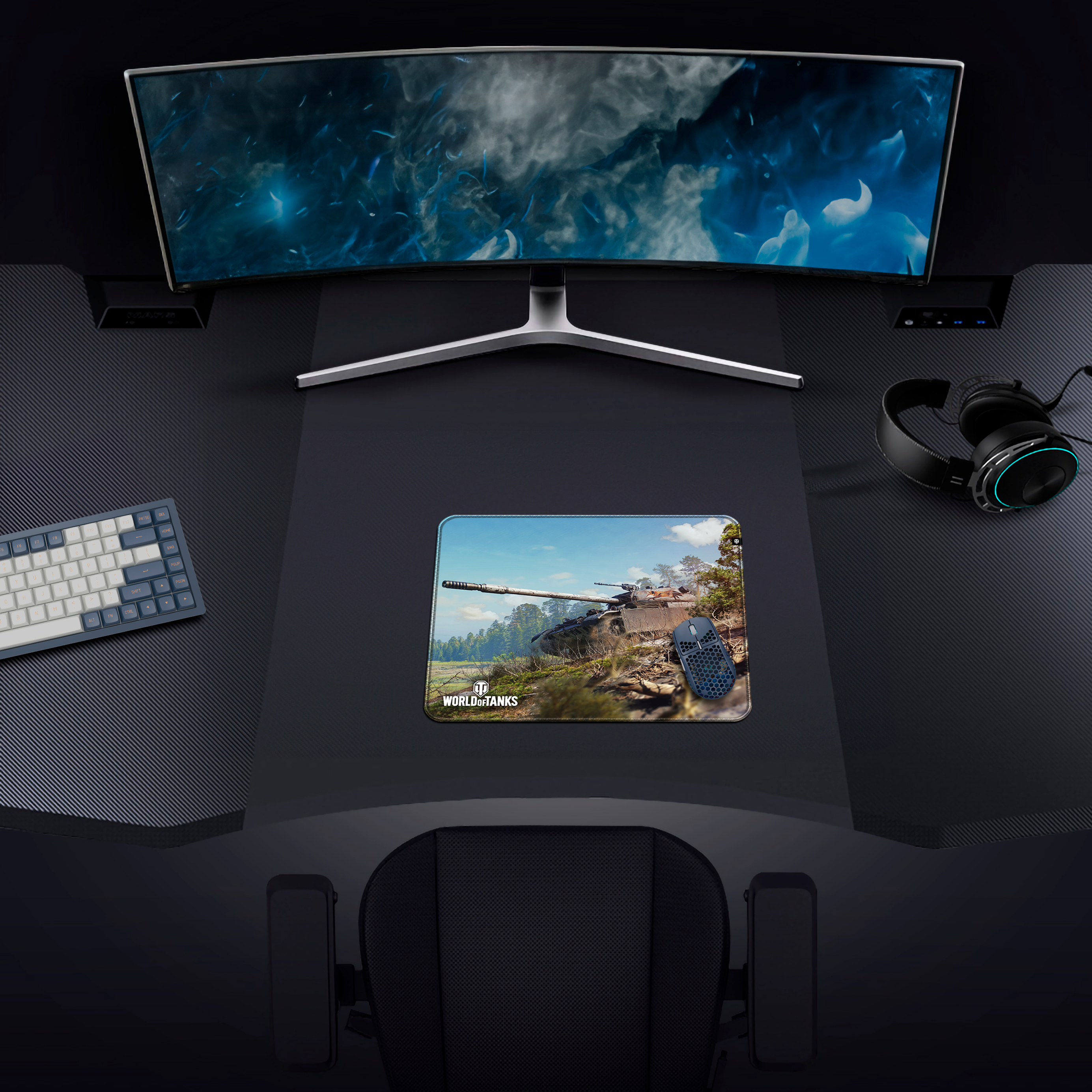 Configurazione di gioco con monitor curvo, tastiera, mouse e cuffie. Mousepad con carro armato di World of Tanks.